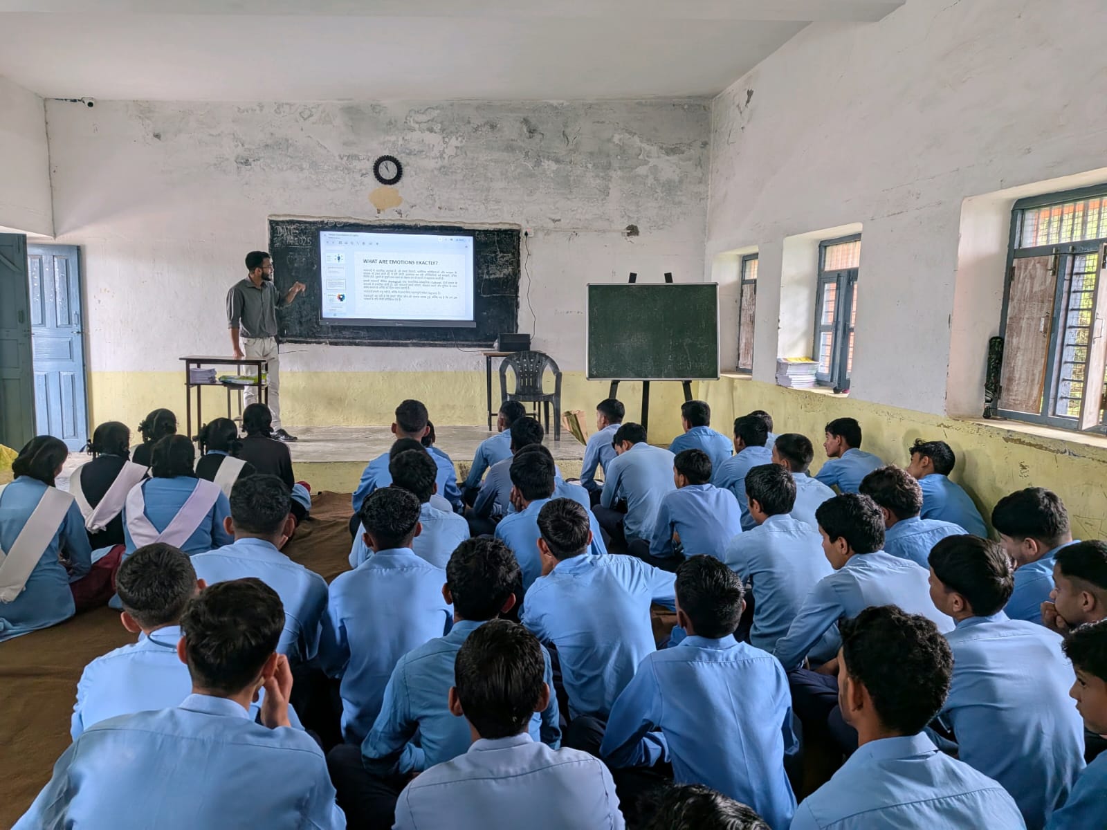 Students filling out survey forms during school session